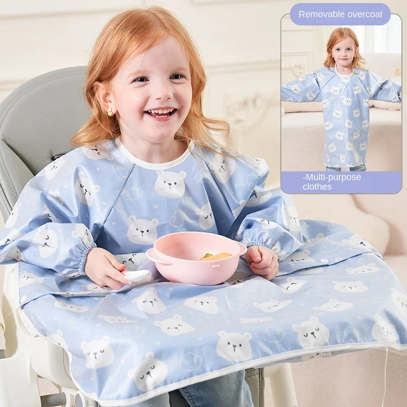 Overhead shot of a baby's feeding area with a blue long-sleeved waterproof bib in use.