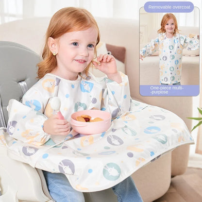 Infant wearing a white long-sleeved waterproof bib with an adorable pattern, staying clean.