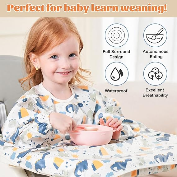A baby giggling while wearing a yellow long-sleeved waterproof bib, perfect for messy eating.