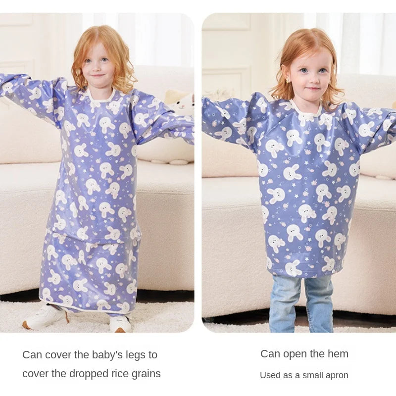 A baby happily painting while wearing a long-sleeved waterproof smock, keeping clothes clean.