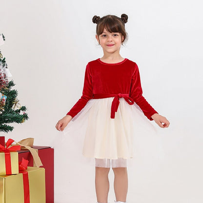 Infant in a red plaid full-body romper, great for family matching and party wear.