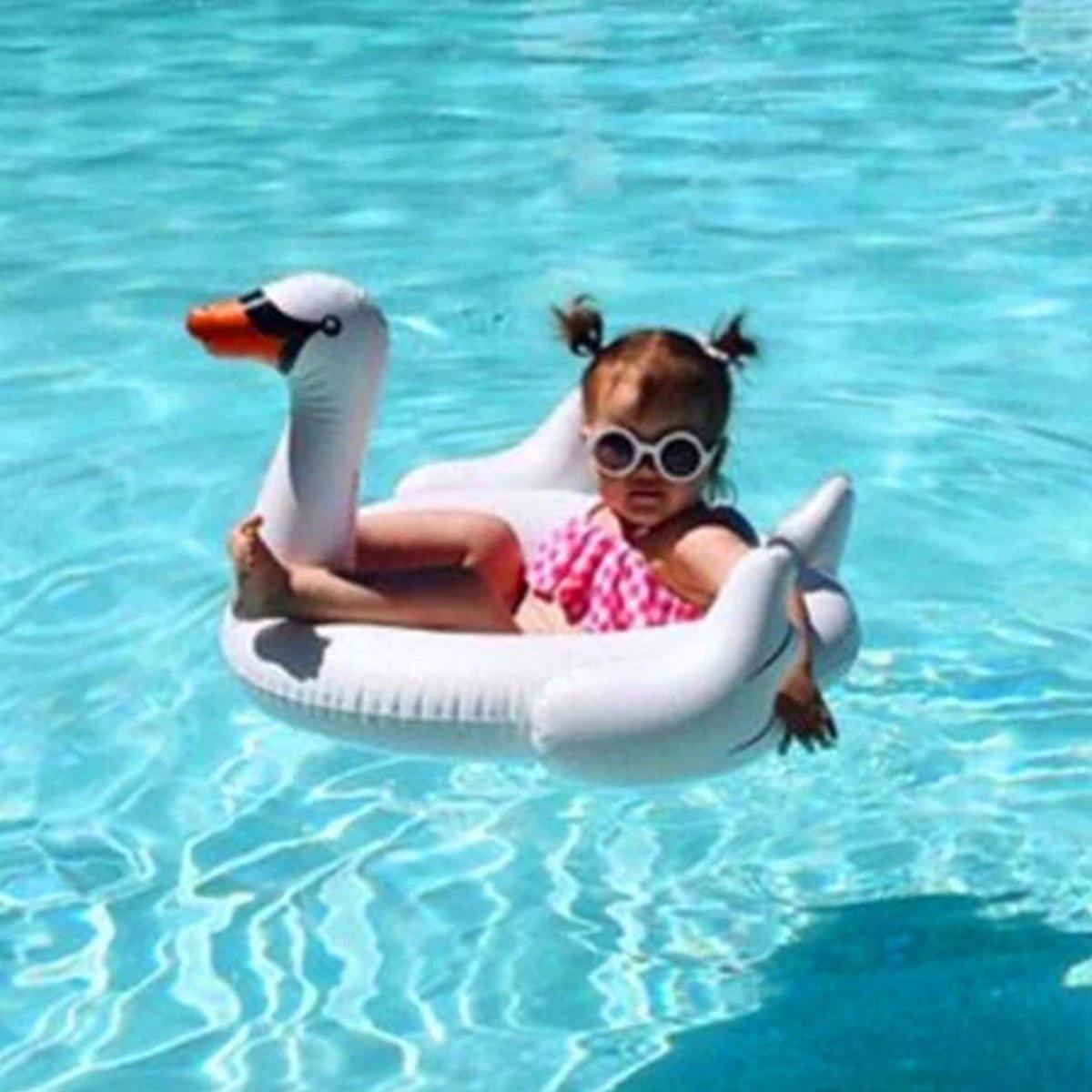 Baby inflatable white swan swimming ring for pool play, floating in water