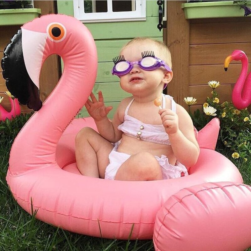 Cute baby in a swan float, a safe and fun inflatable for kids pool time