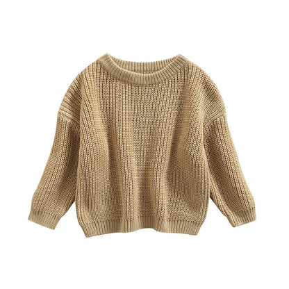Back view of a baby wearing a grey knitted sweater, simple and cozy baby clothing.