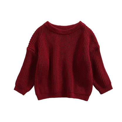 Detailed stitching on a long sleeve baby pullover, showcasing craftsmanship for infants.