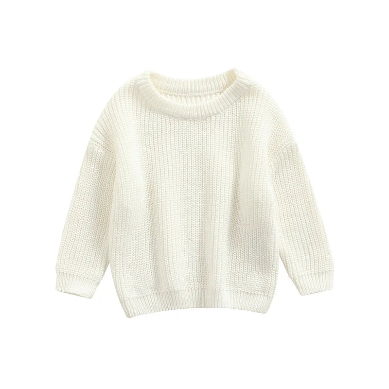 Baby crawling happily in a blue knitted sweater, freedom of movement in cozy apparel.