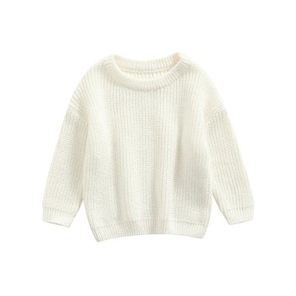 Baby crawling happily in a blue knitted sweater, freedom of movement in cozy apparel.