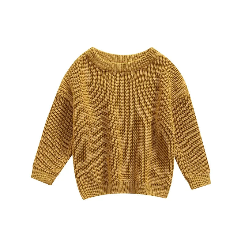 Close-up of the bottom hem of a knitted baby pullover, neat finish for toddler fashion.