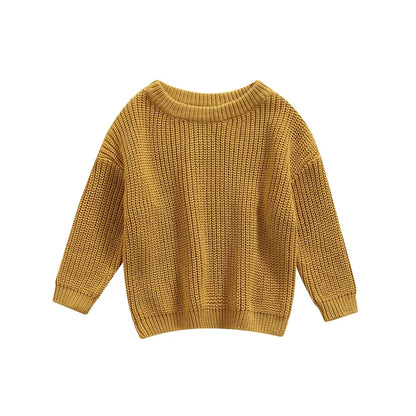 Close-up of the bottom hem of a knitted baby pullover, neat finish for toddler fashion.
