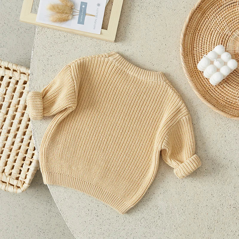 Toddler long sleeve knitted top in soft grey, a versatile cotton blend baby sweater.