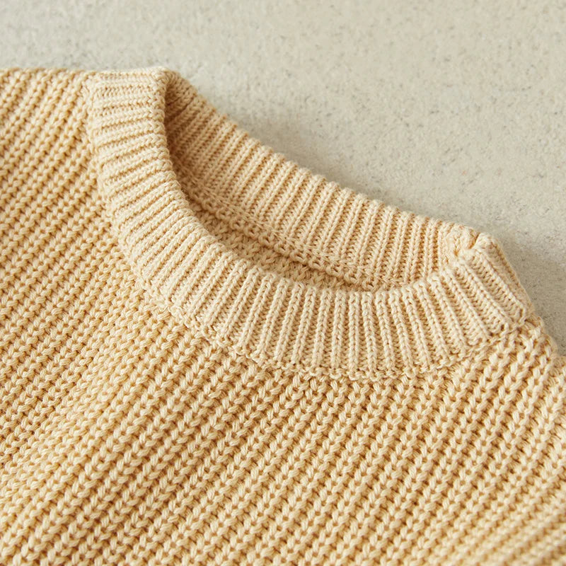 Close-up of knit texture on blue baby pullover, highlights the quality of infant apparel.