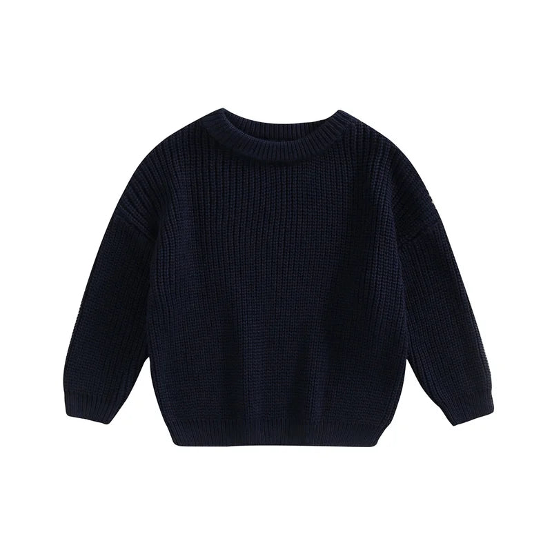 Adorable baby in a grey knitted sweater smiling, cozy and stylish infant apparel.