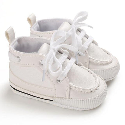 Toddler ankle boots made of supple leather with a soft sole and adjustable lace-up fit, perfect for walkers.