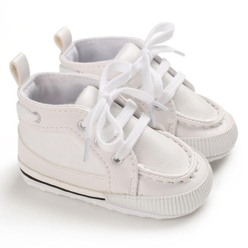 Pair of tan leather baby boots with soft sole, ideal for toddlers learning to walk and baby fashion.