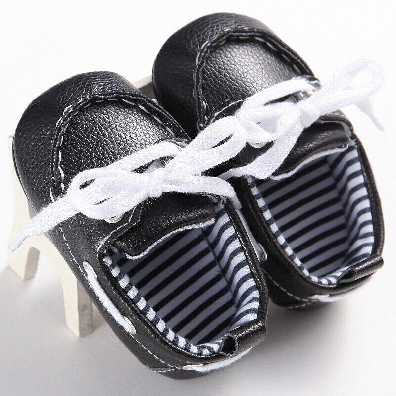 Close-up of brown baby leather loafer boots, ideal first walker shoes with comfortable soft sole.