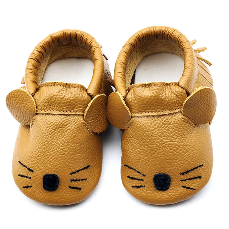 Detailed view of the soft genuine leather of a white baby slipper moccasin