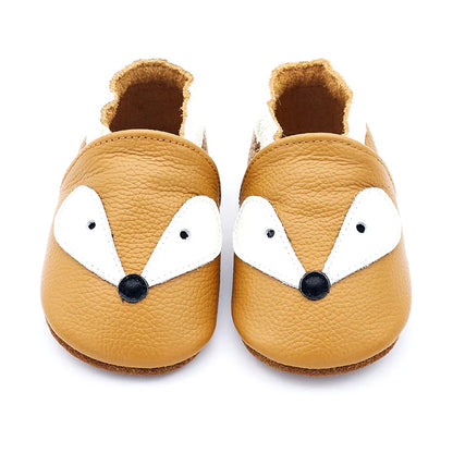 Newborn baby leather moccasins in various earthy tones, arranged artfully