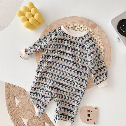 Front view of an infant long sleeve romper in a diamond knit, a must-have baby clothing item