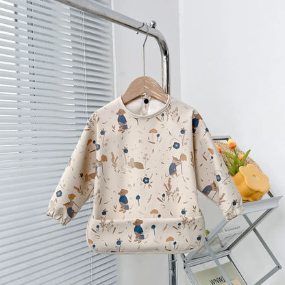 Back of a long sleeve baby bib showing secure tie or snap closure for a comfortable fit