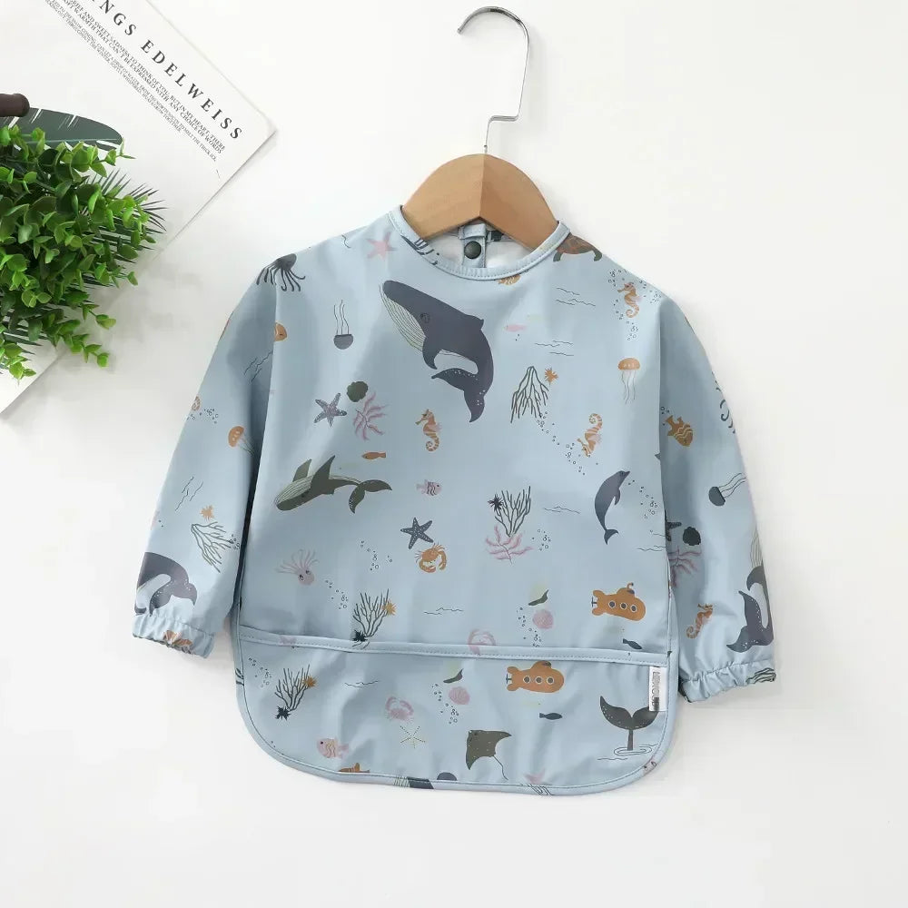 Easy clean long sleeve waterproof bib with a catch-all pocket for fallen food