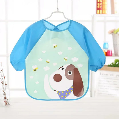 Overhead shot of a baby in a long sleeve waterproof bib, ready for a messy meal