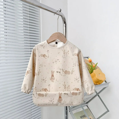 Different patterns available for the long sleeve waterproof baby bib series, a stack view