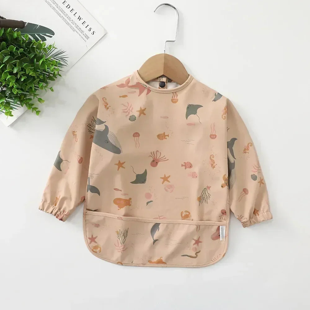 Detailed view of the soft yet durable material of the long sleeve waterproof toddler bib