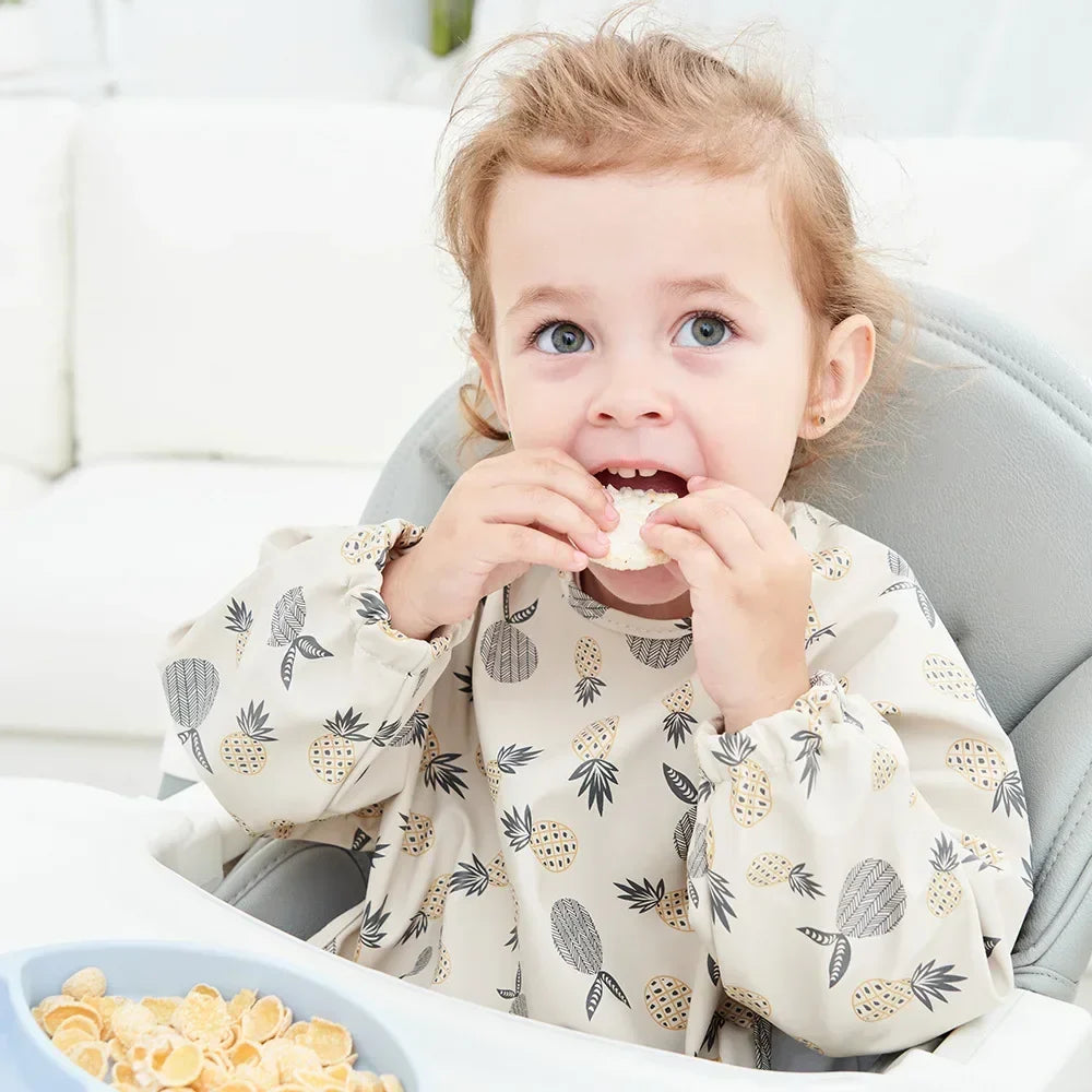 Pink long sleeve baby bib, waterproof and easy to wipe clean, perfect for messy eaters