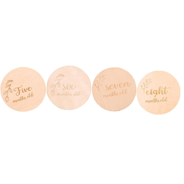 Close-up of elegant wooden baby milestone cards, 12 month set for baby pictures, newborn keepsake