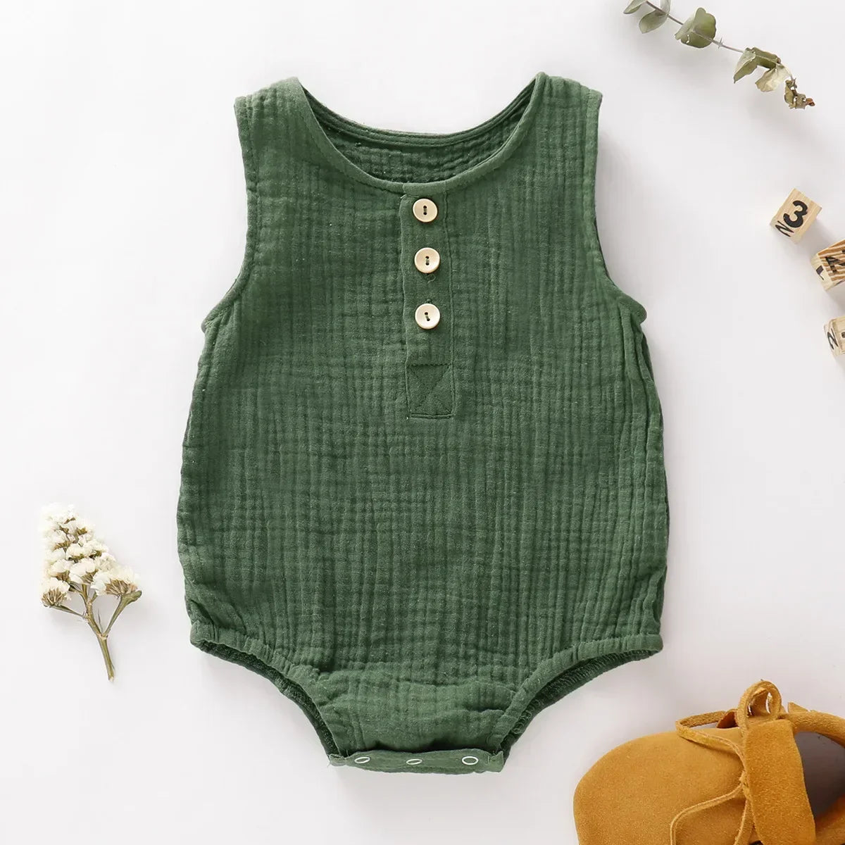 Light blue muslin baby romper, sleeveless one-piece outfit ideal for summer playtime and comfort.