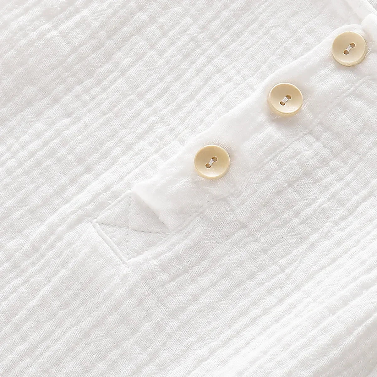 Unisex baby romper in soft muslin, light and breathable sleeveless design for warm weather.