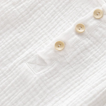 Unisex baby romper in soft muslin, light and breathable sleeveless design for warm weather.
