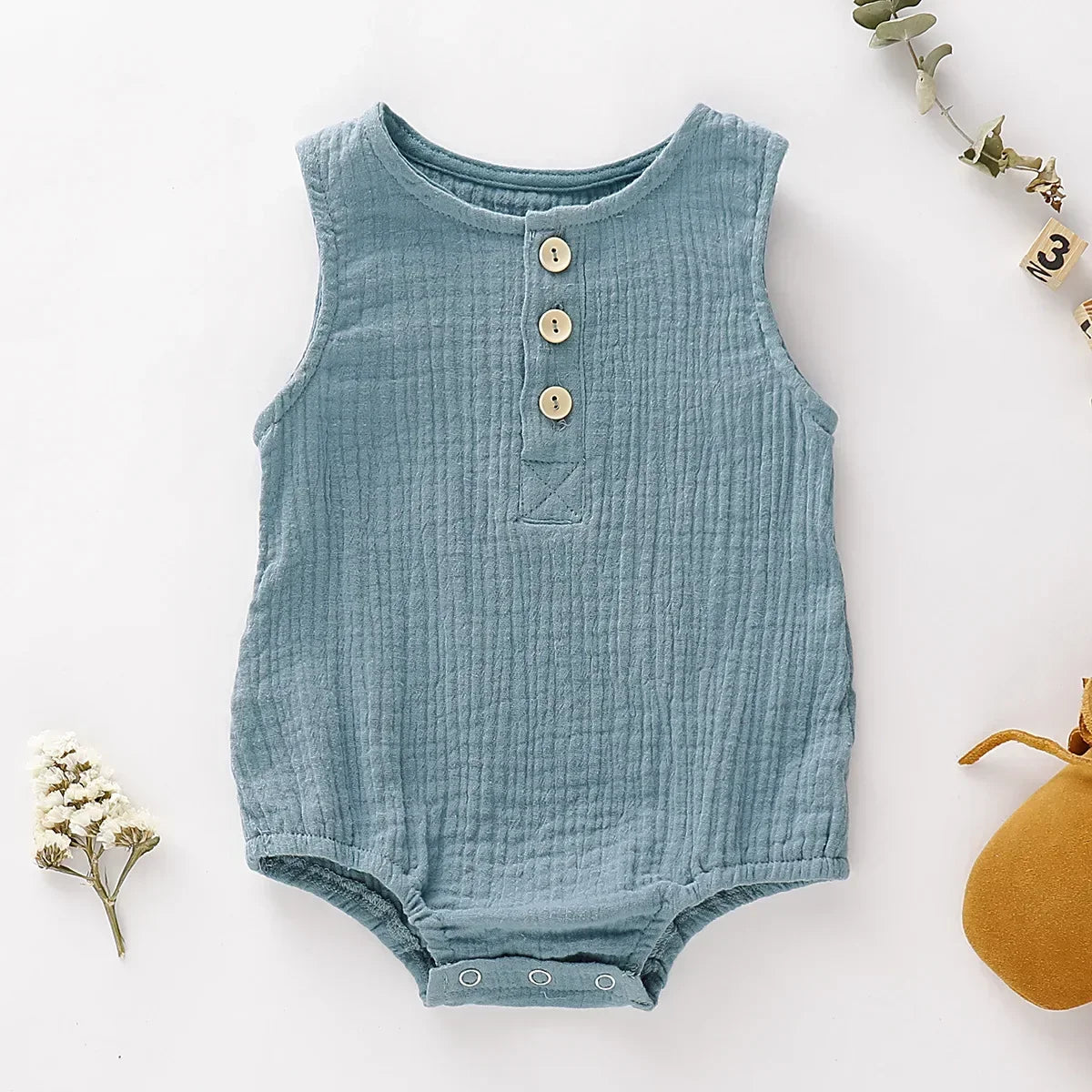 Organic cotton gauze baby romper, sleeveless design perfect for sensitive infant skin in summer.