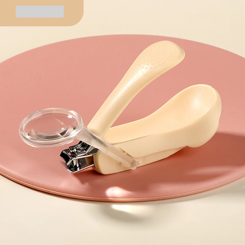 White baby nail clippers with a magnifying glass, a must-have for safe newborn nail care and grooming.