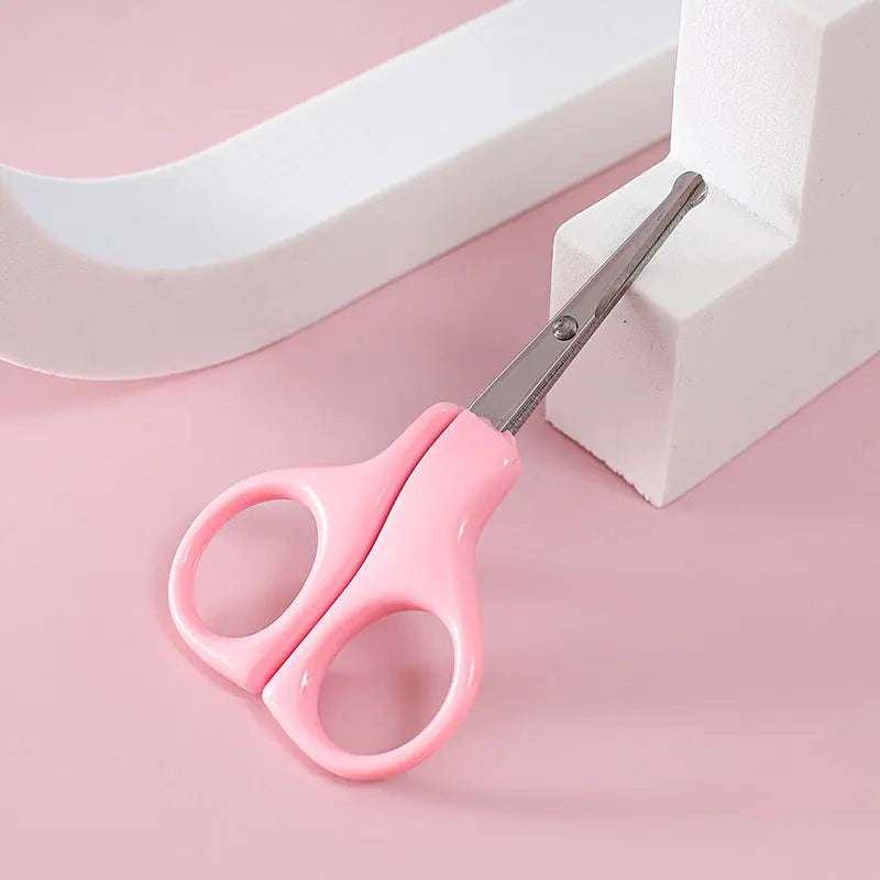 White baby nail clippers with a protective cover, prioritizing safety and hygiene for infants.