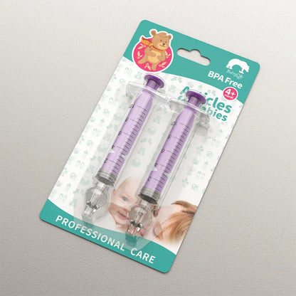 Shot of the Baby Nasal Aspirator Kit alongside a measuring spoon for saline solution preparation.