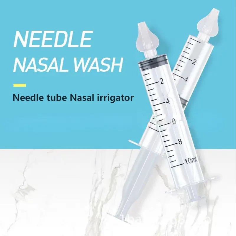 Components of the nasal aspirator kit laid out: aspirator, case, and extra silicone tips for hygiene.