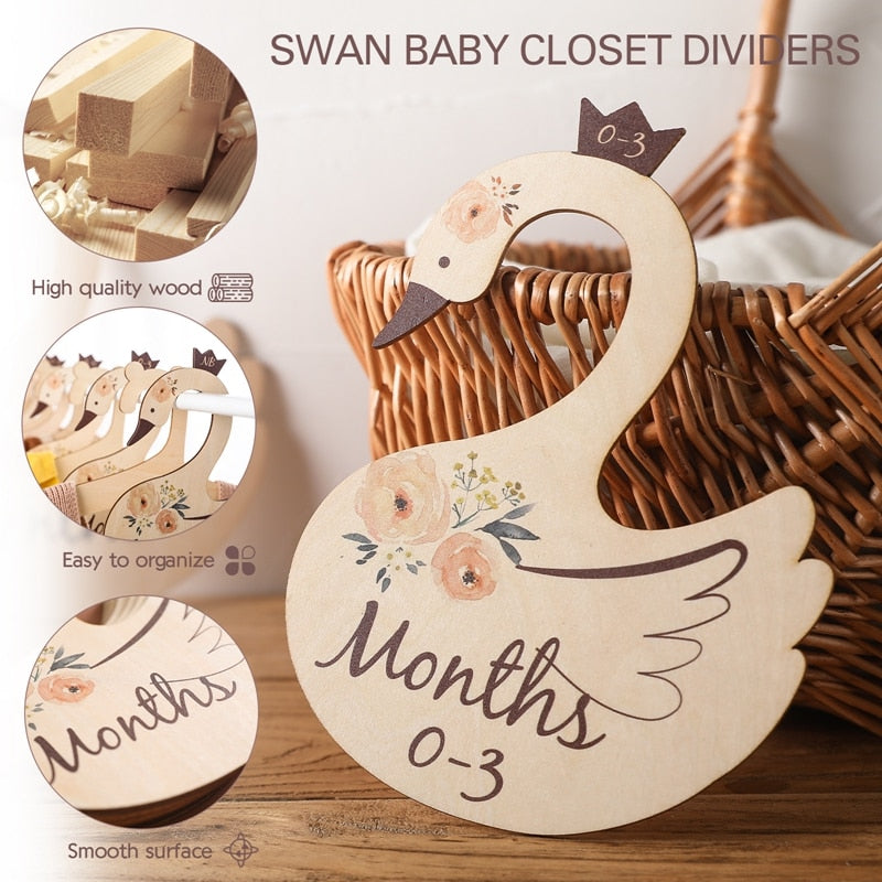 Organized baby closet using wooden cartoon dividers, showing different clothing size labels