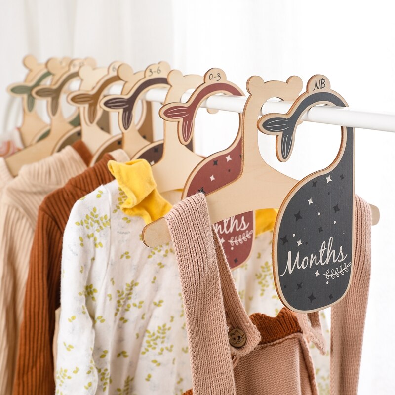 Close-up of a wooden baby closet divider with an adorable cartoon animal, for nursery decor