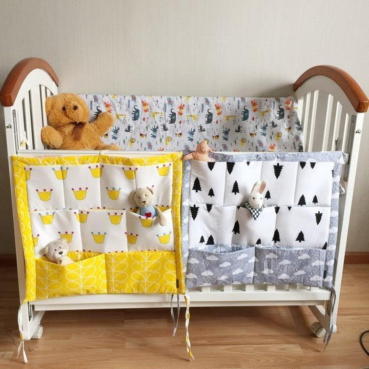 Baby nursery crib organizer for essential storage of diapers, wipes, and toys.
