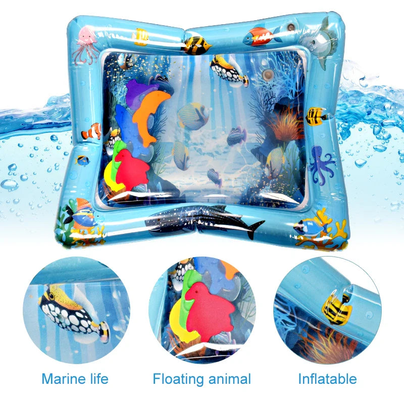 Overhead shot of baby reaching for floating objects in clear inflatable tummy time water mat