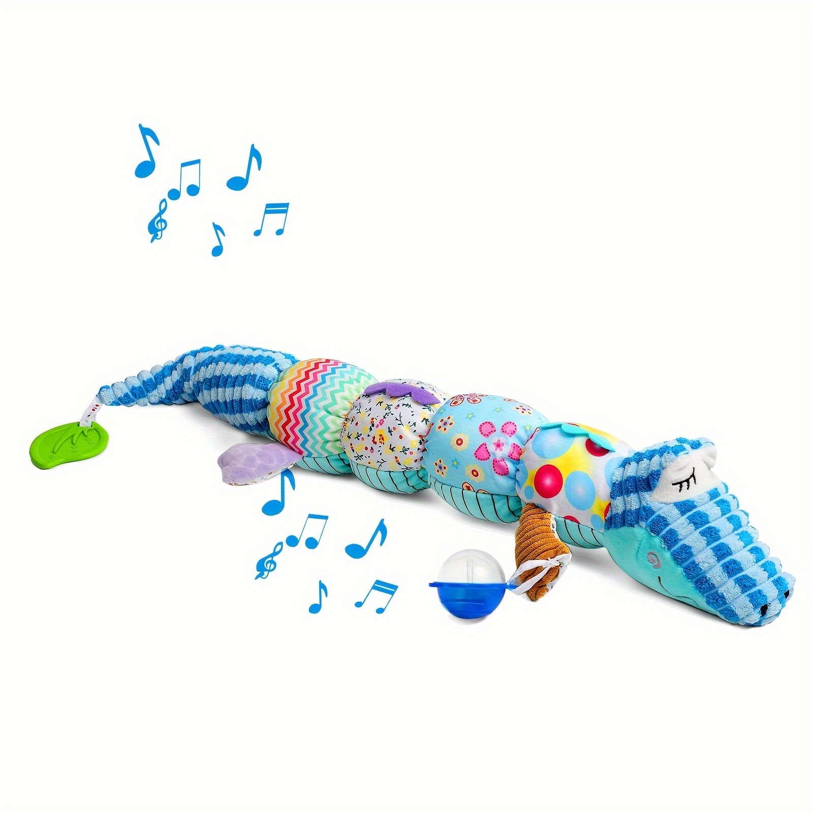 Infant reaching for a hanging plush musical rattle toy, encouraging motor skills development.