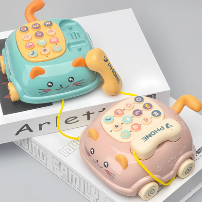 Baby presses buttons on an interactive learning phone toy with colorful lights and sounds, aiding cognitive development.