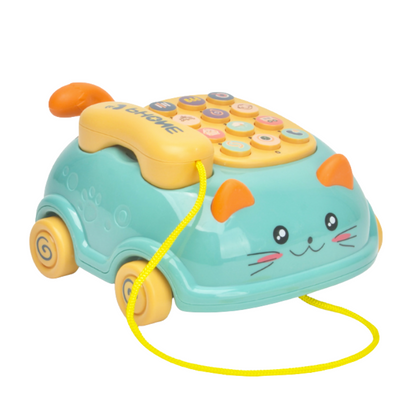 Close-up of a baby's hand playing with an interactive learning phone toy, highlighting numbers and animal sounds.