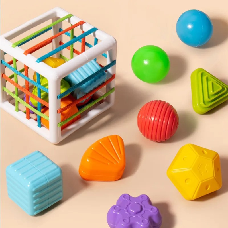 Baby pushing a red star into an Interactive Shape Discovery Fun Cube, enhancing motor skills and sensory play.