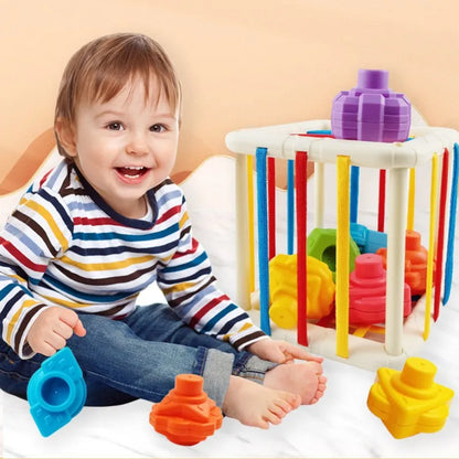 Toddler playing with Baby Rainbow Shape Sorter, promoting fine motor skills
