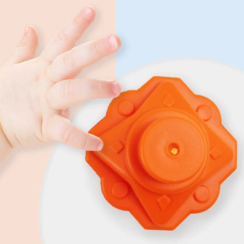 Toddler arranging shapes in the Rainbow Shape Sorter, concentration skill building