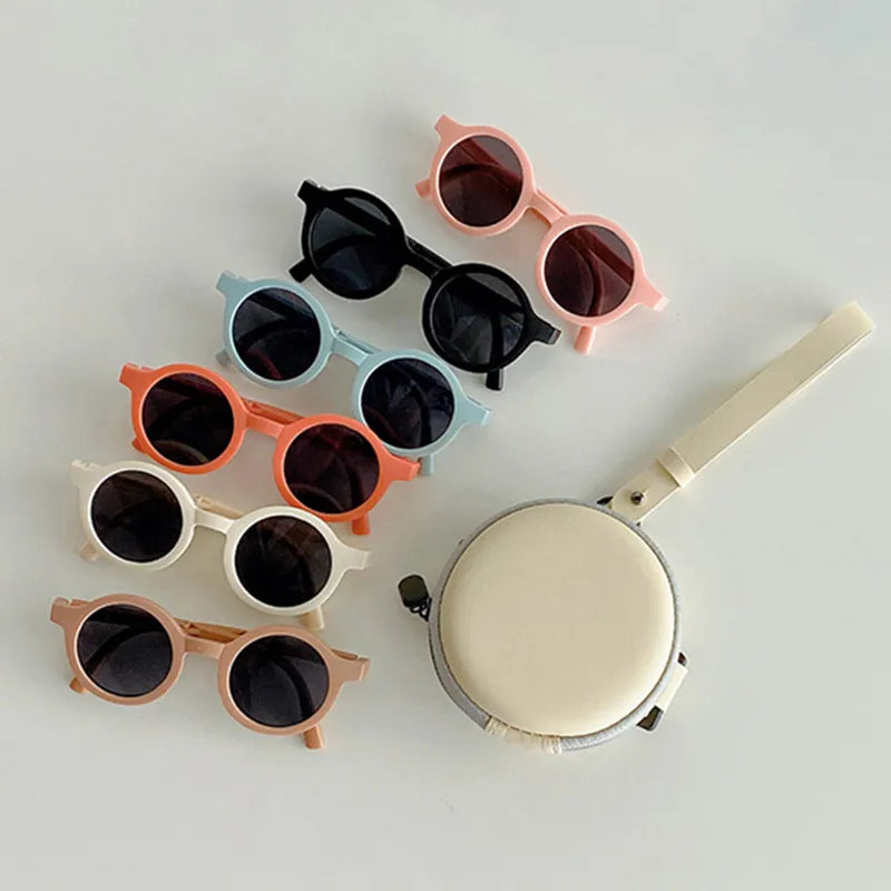 Infant shades for beach day: blue retro foldable round sunglasses protecting baby's eyes