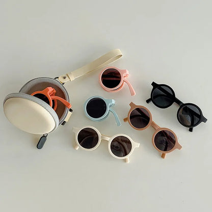 Overhead shot of retro foldable round baby sunglasses, showcasing lightweight design