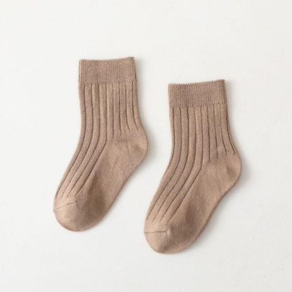 Close-up of vibrant high neck ribbed baby socks, soft cotton for little feet.